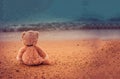 Teddy bear sit alone at the seashore Royalty Free Stock Photo