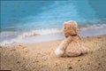 Teddy bear sit alone at the seashore Royalty Free Stock Photo