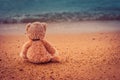 Teddy bear sit alone at the seashore Royalty Free Stock Photo