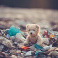 A teddy bear sits in a pile of garbage, AI