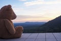 Teddy bear sitting alone on a wooden balcony. Look sad and lonely Royalty Free Stock Photo