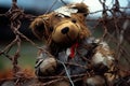 Teddy bear is sitting behind barbed wire fence with red tie. Generative AI