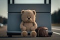 Teddy bear sitting on the bus stop and waiting for transport