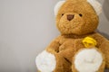 Teddy bear sitting on top of a piece of furniture