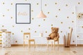 Teddy bear on small chair Royalty Free Stock Photo