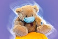 Teddy Bear with thermometer in surgical mask isolated on black background. Child kid coronavirus protection concept. Face mask Royalty Free Stock Photo