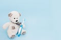 Teddy bear with a toothbrush blue background . copy space Royalty Free Stock Photo