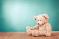 Teddy Bear toy alone on wood in front mint blue background. Vintage style filtered photo Royalty Free Stock Photo