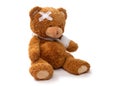 teddy bear toy with bandaged paw and patch on head