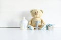 Teddy bear toy, gift box, digit one on white table with copy space. Baby shower, accessories, decorations, stuff