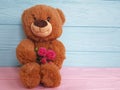 Teddy bear toy on a wooden family rose