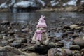 Teddy bear in warm clothes sits in the riverside Royalty Free Stock Photo