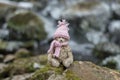 Teddy bear in warm clothes sits in the riverside Royalty Free Stock Photo