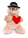 Teddy bear wearing hat holds red heart Royalty Free Stock Photo