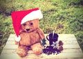 Teddy bear wearing santa claus hats and coffee cup on a wooden t Royalty Free Stock Photo