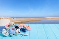 Teddy bear with white alarm clock,Beach accessory,hat,sunglasses,shoes on blue wooden plank background, concept summer holiday ba Royalty Free Stock Photo