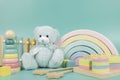 Teddy bear, wooden rainbow, educational and music baby toys on light blue background Royalty Free Stock Photo