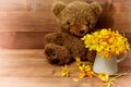 Teddy bear with a yellow bouquet of flowers