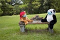 Teddy bears on a bench socially distancing with masks on