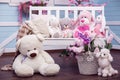 Teddy bears, Bunny and plush poodle sitting on and near white wooden bench