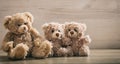 Teddy bears family sitting on a wooden background Royalty Free Stock Photo