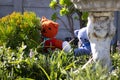 Teddy bears hiding behind plants in a garden