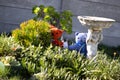 Teddy bears hiding behind plants in a garden