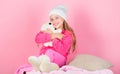 Teddy bears improve psychological wellbeing. Kid cute girl play with soft toy teddy bear pink background. Child small