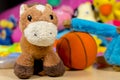 Teddy donkey in front of others baby toys