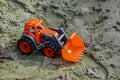 Children`s toy tractor in the sand Royalty Free Stock Photo