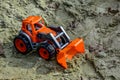 Children`s toy tractor in the sand Royalty Free Stock Photo