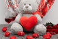 Teddybear holding heart, with red wine glasses for Valentines day