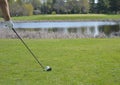 Golfer Teeing off in front of a Water trap Royalty Free Stock Photo
