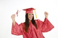 Beautiful Caucasian woman wearing a red graduation gown holding diploma Royalty Free Stock Photo