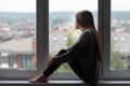 Teen abuse,teenager has depression,a young girl is unhappy,upset, looks out the window Royalty Free Stock Photo