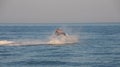 Teen age boy skiing on water scooter. Young man on personal watercraft in tropical sea. Active summer vacation for