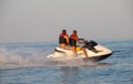 Teen age boy skiing on water scooter. Young man on personal watercraft in tropical sea. Active summer vacation for