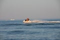 Teen age boy skiing on water scooter. Young man on personal watercraft in tropical sea. Active summer vacation for