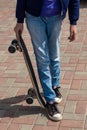 Teen age Girl in black sneakers on a skateboard. Feet on a skateboard