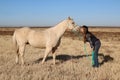 Teen-age girl showing some love to her horse in open field Royalty Free Stock Photo