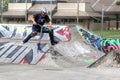 Teen-aged boy practicing on scooter at skate-park Royalty Free Stock Photo