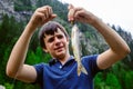 Teen ager fisherman shows happy, catching an Salvelinus alpinus