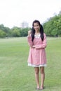 Teen beautiful girl Dress pink happy and relax On Park Royalty Free Stock Photo