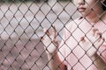 Teen behind the cage or woman jailed Royalty Free Stock Photo