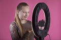 Teen blogger considers the ring lamp with camera holder