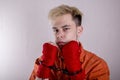 Teen boxer in handcuffs on a gray background.Concept: athletes are hooligans. Juvenile delinquent, criminal liability of minors. M Royalty Free Stock Photo