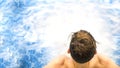 Teen boy attractive , handsome caucasian brunette guy in bubbles jacuzzi , standing in luxury spa pool , leisure wellness. Royalty Free Stock Photo