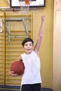 Teen boy with basketball ball in gym