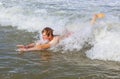 Teen boy is body surfing in the ocean