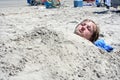 Teen Boy Buried in Sand Royalty Free Stock Photo